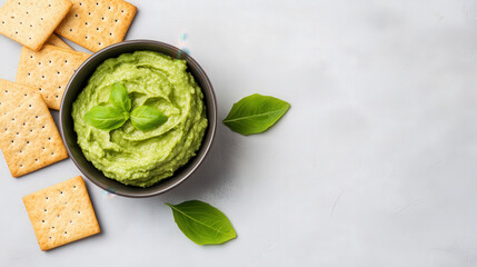 Wall Mural - Bowl of fresh guacamole with a side of whole grain crackers