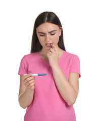 Wall Mural - Confused woman holding pregnancy test on white background