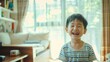 © VK Studio - A young boy beams with joy in a light-filled living room, wearing a striped shirt.