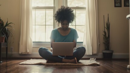 Sticker - A woman sits cross-legged on the floor, intently working on her laptop in a sunlit room with windows, surrounded by houseplants, portraying focus and tranquility.