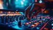 © Rossarin - A musician adjusts audio levels on a professional mixer in a vibrant setting, creating an engaging atmosphere for sound creation.
