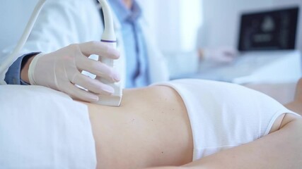 Wall Mural - Doctor man wearing a white coat using an ultrasound machine on a female patient examining internal organs, closeup vie. Medicine service