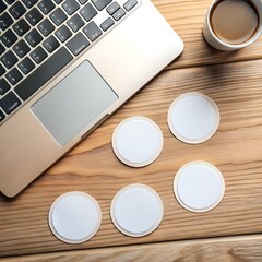 A minimalist mockup featuring five blank white round stickers arranged on a wooden table beside a laptop.