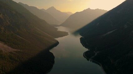Wall Mural - experience the stunning aerial view of lake plansee, surrounded by majestic mountains in tyrol, aust