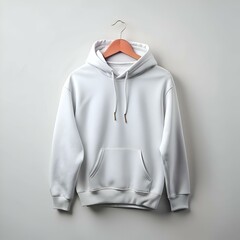 A clean and simple white hoodie mockup hanging on a wooden hanger. perfect for showcasing your designs or brand logos.