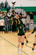 © Leah Flores/Stocksy - High School Athlete Hitting Volleyball on Court