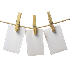 Three white papers are hanging on twine with wooden pegs. Papers overlap, are blank, and can be written on. Pegs are uniform, twine is taut, against a white background