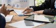 © Kritdanai - Business Meeting: A close-up shot of a business meeting, with a focus on hands and paperwork, showcasing the intensity and focus of strategic planning.