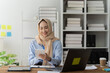 © Kritdanai - Smiling Muslim Businesswoman Working on Tablet in Office
