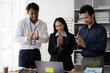 © Kritdanai - Applauding Success: Three diverse colleagues celebrate a shared triumph, their laughter and applause reflecting the joy and unity of a collaborative workplace.