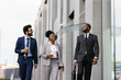 © Oleksii Syrotkin/Stocksy - Corporate manager talking to office workers outdoors