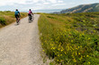 © Christine La/Stocksy - Two cyclist riding together in nature