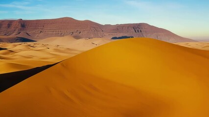 Poster - The wind is creating beautiful shapes in the sand, while the sun bathes the scene in a warm, golden light, casting a magical and surreal glow over the vast desert landscape