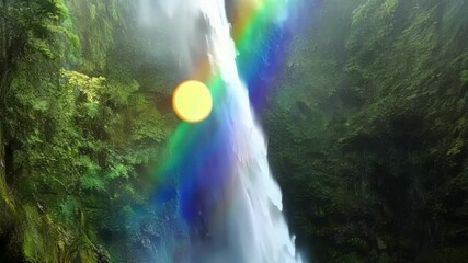 Aufkleber - Stunning waterfall cascading down a rocky cliff in a vibrant green forest, painting a rainbow across the sky and creating a magical atmosphere