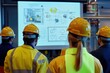 © JERRYsnipe.AI - A team of industrial workers attending a safety training session, with diagrams of emergency procedures on a screen, representing the emphasis on safety education in the workplace