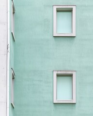 Poster - Modern Minimalist Architecture with Pastel Teal Windows on Soft White Facade, Low-Angle Daytime , Serene Contemporary Aesthetic