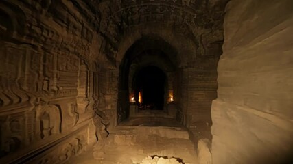 Aufkleber - Walking through a dark stone tunnel lit by torches, shadows dance on the walls, evoking a mysterious and eerie atmosphere perfect for fantasy games or illustrations