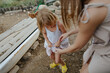© Anna Artemenko/Stocksy - woman with little daughter collecting eggs in a chicken coop