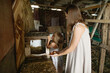 © Anna Artemenko/Stocksy - woman with little daughter collecting eggs in a chicken coop