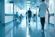 © Shamsiyya - Blurred hospital corridor with people walking and medical staff working in the background, blurred background concept for health care, photo on white isolated background.