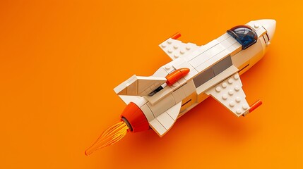 Spaceship toy on orange background