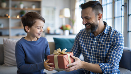 Wall Mural - Happy father and son giving gift box to each other at home. Cheerful little boy giving present to his dad. Family holiday concept