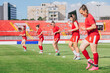 © Jovana Milanko/Stocksy - Female Football Players Warming Up Before the Game