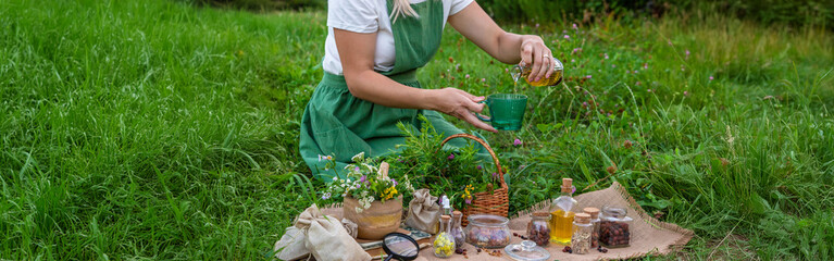 Wall Mural - woman and herbal tinctures, tea, medicinal herbs.