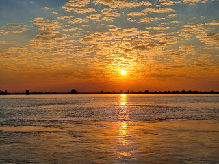 Sunset scenery of Padma river with orange cloud and blue sky