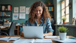© DreamForge Studio - A young woman with curly brown hair working on a laptop computer in a busy office environment, surrounded by various documents and office supplies