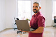 © Manu Padilla/Stocksy - Confident businessman working on netbook at office