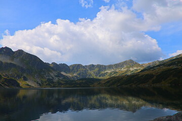 view of the Great Polish Pond and the surrounding mountains in the Valley of Five Polish Ponds in the Tatra Mountains in Poland