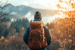 © Hunman - Back view of unrecognizable solitary hiker admires the view of the mountain during autumn, with warm light.