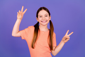 Poster - Photo portrait of cute little girl show v-sign dressed stylish red clothes isolated on violet color background