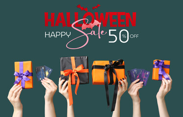 Poster - Female hands holding Halloween gifts and credit cards on green background