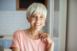 © Marko Geber - Smiling senior woman portrait in modern kitchen