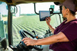 © Marko Geber - Middle aged female farmer driving tractor on field