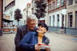 © Davor - Senior couple laughing and exploring city with a map