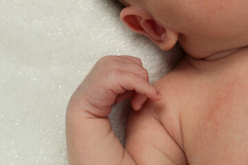 Newborn on a sparkly white blanket