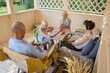 © Evgenij Yulkin/Stocksy - Little sisters play domino with grandparents