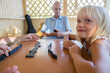 © Evgenij Yulkin/Stocksy - Little girl plays dominoes with her family