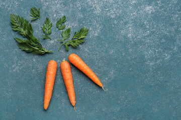 Fresh carrots on green background