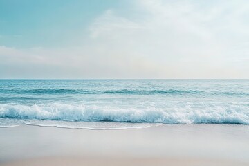 Wall Mural - serenity at sandy beach with gentle waves and clear sky