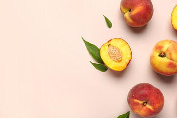 Sweet peaches and leaves on beige background