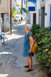 © aerogondo - Elderly woman enjoying vacation at streets of Glossa, Skopelos , Greece