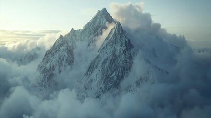 Sticker -  Aerial view of a cloud-shrouded mountain summit, with the peak prominently featured in the foreground