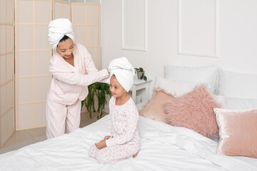 Wall Mural - Asian mother with her little daughter after shower in bedroom