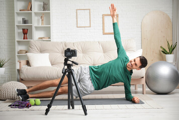 Poster - Sporty happy male blogger training and recording video at home