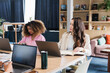 © Daniel Zapata/Stocksy - Portrait of two young women working in the office.
