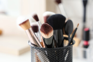 Wall Mural - Holder with makeup brushes at home, closeup